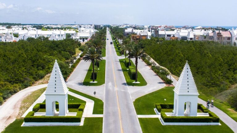 White stucco homes and palm trees along a quiet street in Alys Beach, Florida